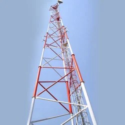 Completed telecom tower with red and white aviation paint and mounted antennas